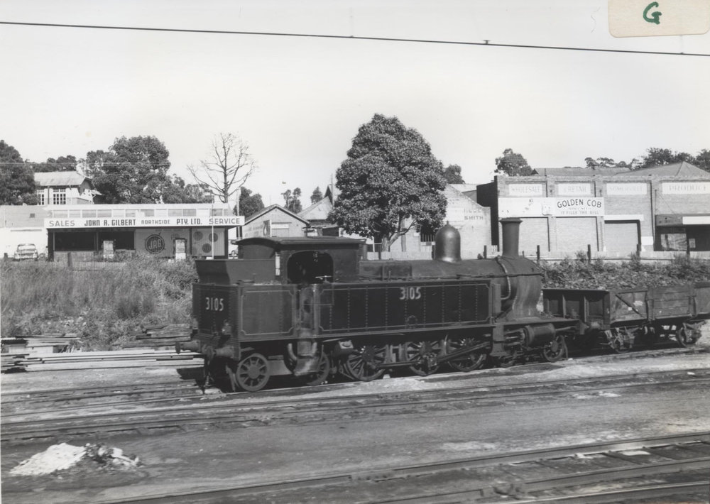 Tank engine shunting a locomotive coal engine with Jersey Street, Hornsby, in the background.