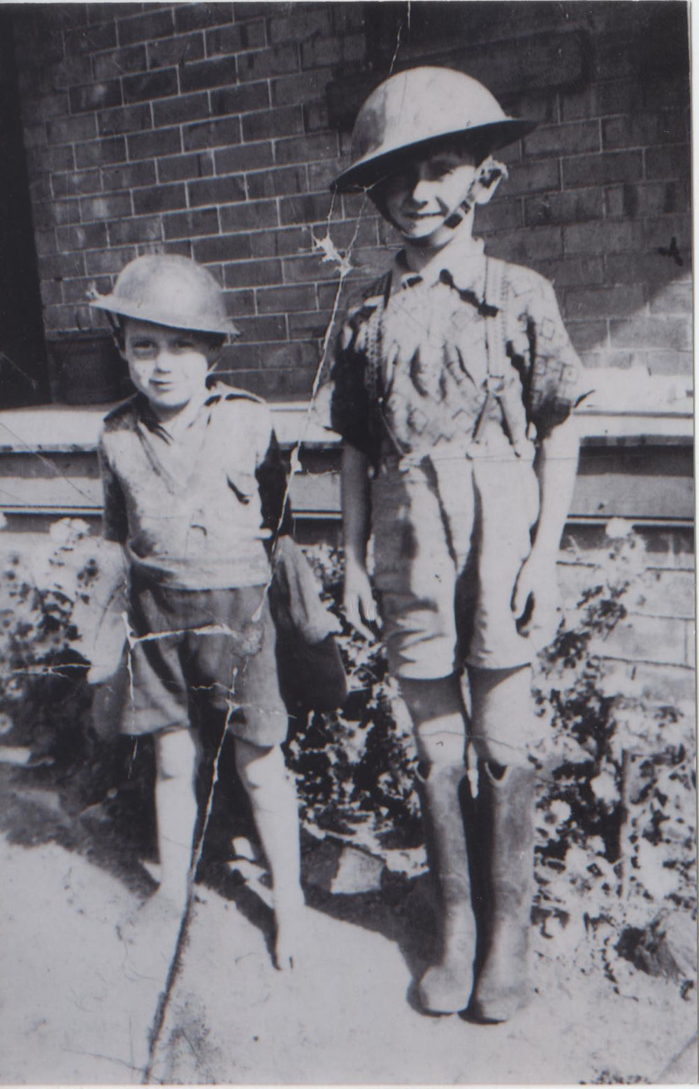 Ted Young (wearing fathers helmet) and Ron Young (with copy)