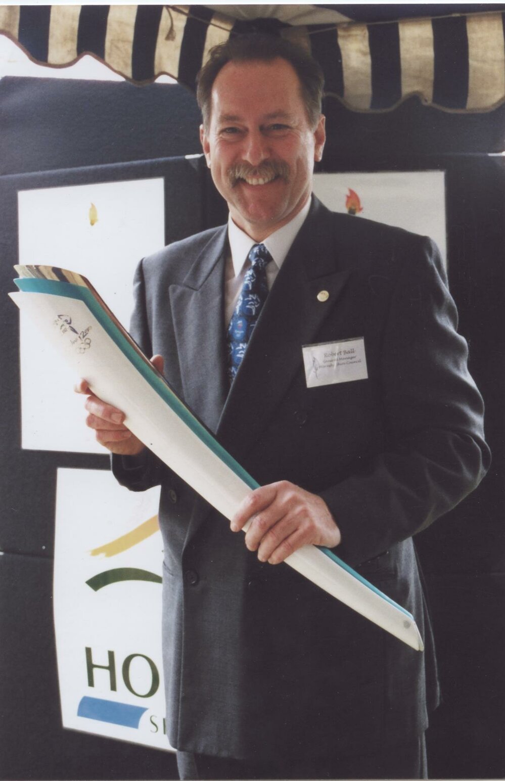 General Manager, Robert Ball, holding the Hornsby Shire Council torch at Pennant Hills Park