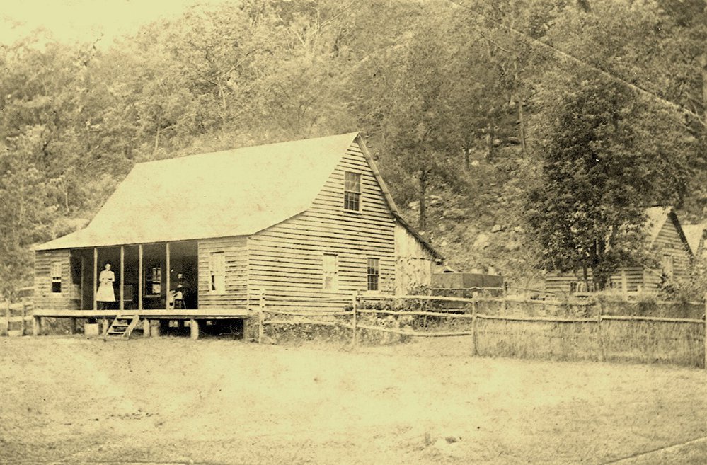 Burton and Mary Crossland in front of the two-storey guest house c.1890
