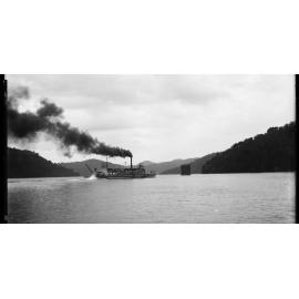 The General Gordon paddle steamer on Hawkesbury River, showing the railway bridge under construction c. 1889