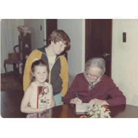 Mary Edgeworth David signing copies of her book "Passages of Time"